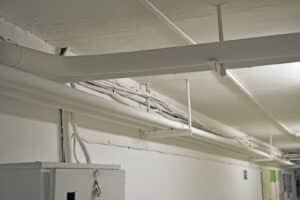 White Water Pipes And Heating In The Basement. Whitewashed Pipes