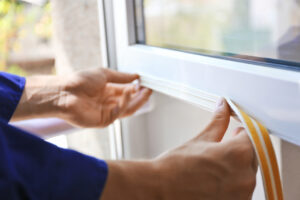Image of a person sealing a window